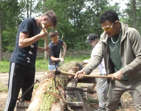 Construction students from West Suffolk College learn how to hand convert a tree into a timber